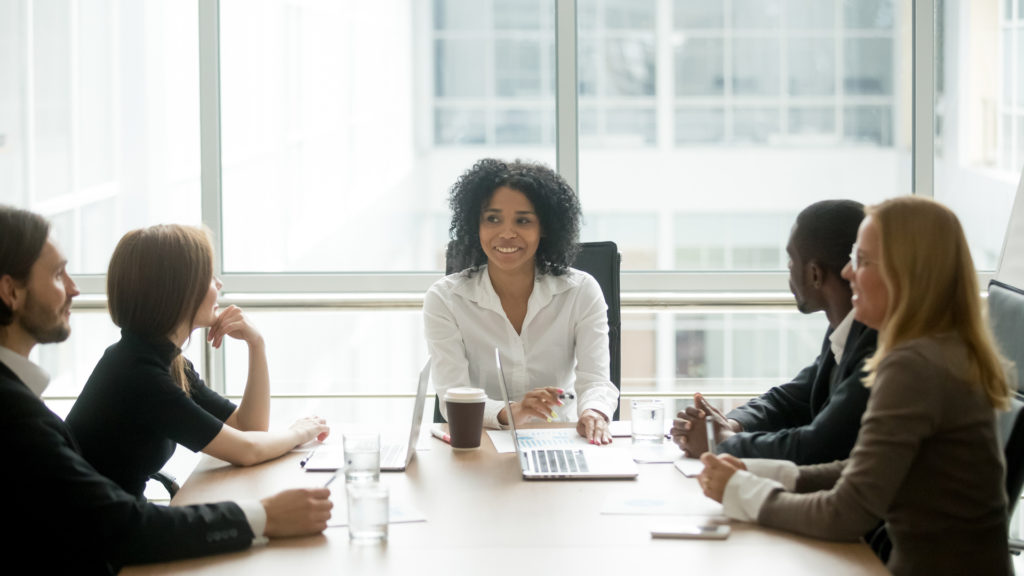 People seated around a conference table, showing good relationship between CEO and board members.