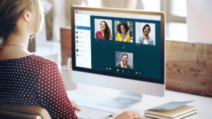 woman working remotely video conferencing with team